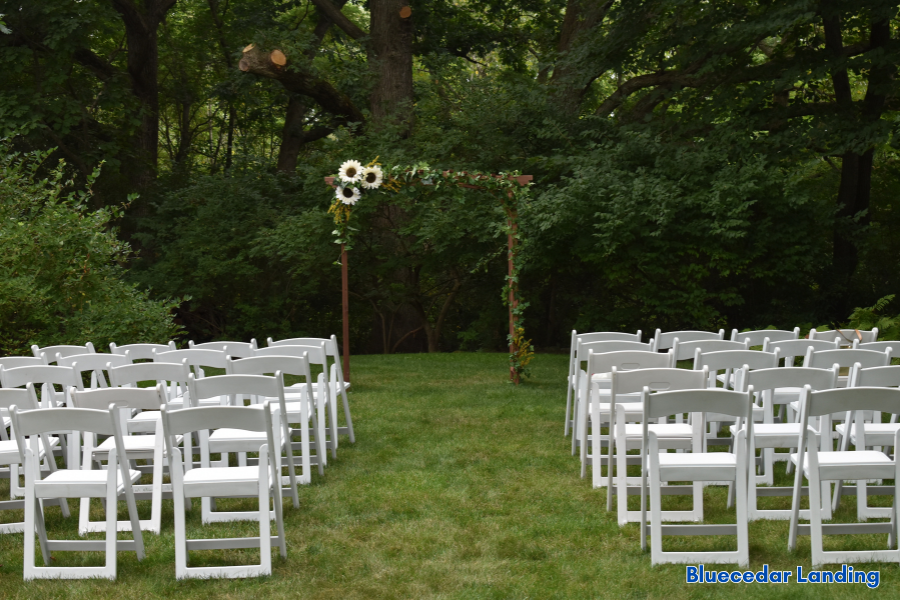 Rustic lakeside wedding venue near Kansas City with wooden ceremony benches and floral aisle at Blue Cedar Landing