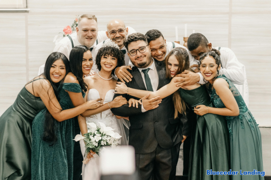 Wedding party celebrating with bride and groom during an indoor reception