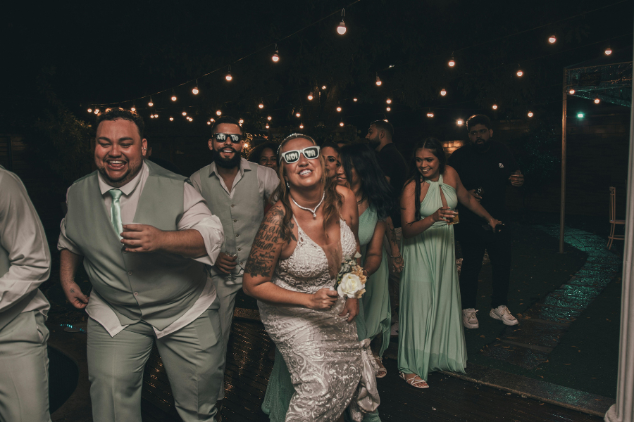 Fall Outdoor Wedding in Missouri: Weather, Sunset, and Backup Planning 3 Bride and wedding guests dancing under string lights at an outdoor wedding reception