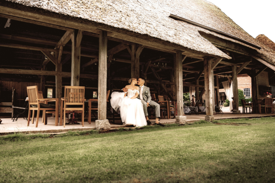 couples sitting in their barn wedding venue 